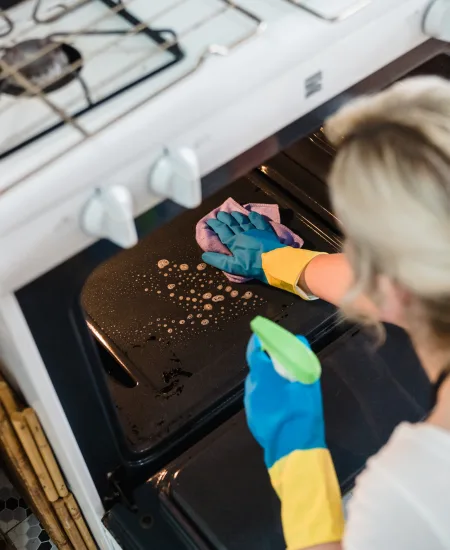 A cleaner scrubbing detail off an oven interior